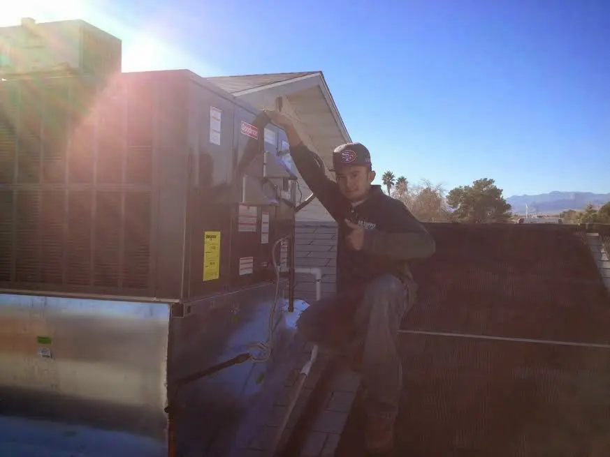 HVAC technician performing HVAC Inspection on a rooftop unit in Henderson